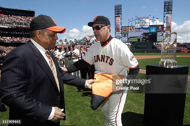 San Francisco Giants manager Bruce Bochy accepts the 2010 World Series flag from former San Francisco Giants player Willie Mayes before the start of...