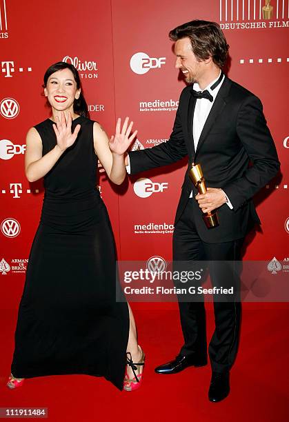 Actress Sibel Kekilli and actor Florian David Fitz pose with his award during the 'Lola - German Film Award 2011' at Friedrichstadtpalast on April 8,...