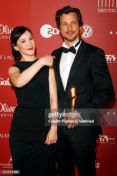 Actress Sibel Kekilli and actor Florian David Fitz pose with his award during the 'Lola - German Film Award 2011' at Friedrichstadtpalast on April 8,...