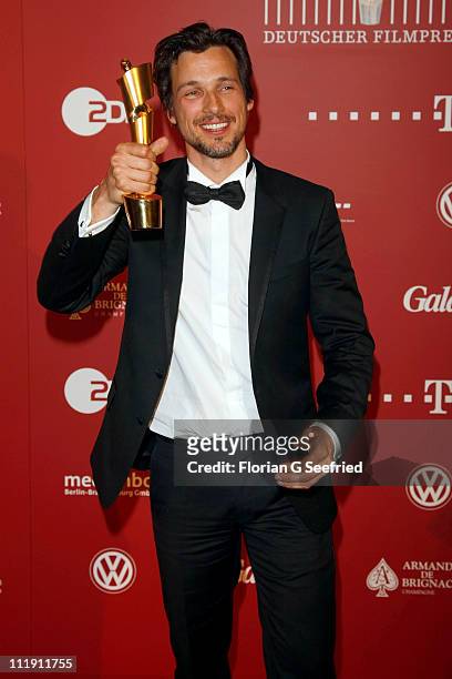 Actor Florian David Fitz poses with his award during the 'Lola - German Film Award 2011' at Friedrichstadtpalast on April 8, 2011 in Berlin, Germany.