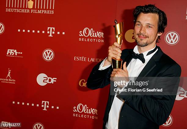 Actor Florian David Fitz poses with his award during the 'Lola - German Film Award 2011' at Friedrichstadtpalast on April 8, 2011 in Berlin, Germany.