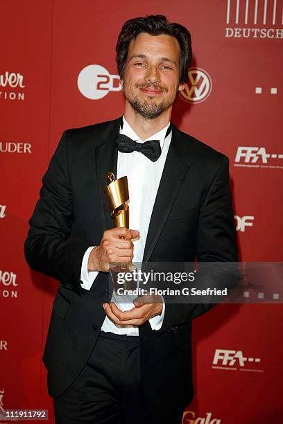 Actor Florian David Fitz poses with his award during the 'Lola - German Film Award 2011' at Friedrichstadtpalast on April 8, 2011 in Berlin, Germany.