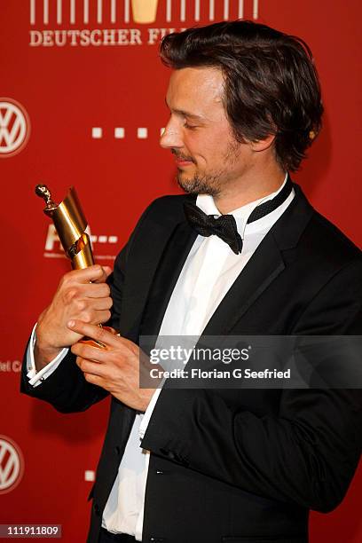 Actor Florian David Fitz poses with his award during the 'Lola - German Film Award 2011' at Friedrichstadtpalast on April 8, 2011 in Berlin, Germany.