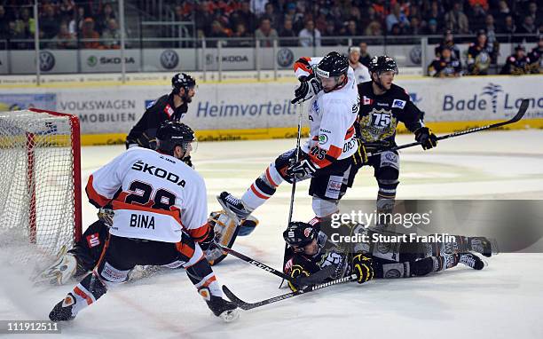 Andreas Morczinietz of Wolfsburg has a shot saved by Scott Langkow of Krefeld during the third DEL play off quarter final match between Grizzly Adams...