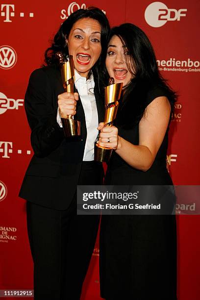 Nesrin Samdereli and Yasemin Samdereli pose with her award during the 'Lola - German Film Award 2011' at Friedrichstadtpalast on April 8, 2011 in...