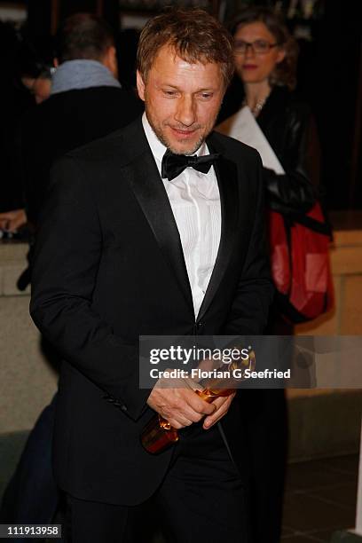 Richy Mueller poses with his award for Best Supporting Actor during the 'Lola - German Film Award 2011' at Friedrichstadtpalast on April 8, 2011 in...