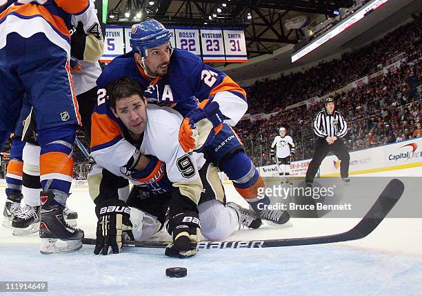Radek Martinek of the New York Islanders stops Pascal Dupuis of the Pittsburgh Penguins in the crease at the Nassau Coliseum on April 8, 2011 in...