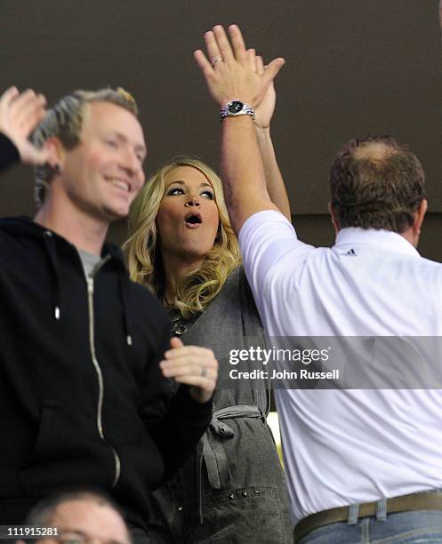 April 8: Carrie Underwood celebrates a Nashville Predators goal with friends against the Columbus Blue Jackets during an NHL game on April 8, 2011 at...