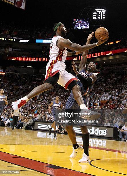 LeBron James of the Miami Heat drives against Kwame Brown of the Charlotte Bobcats during a game at American Airlines Arena on April 8, 2011 in...