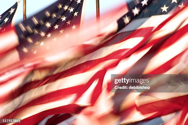 still shot of american flags whipping in the wind - pics of us flag stock pictures, royalty-free photos & images