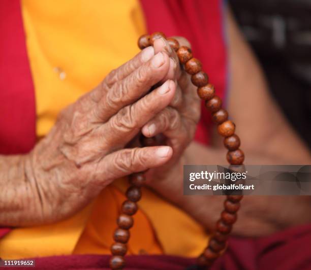 buddhist nun praying with mala prayer beads - buddist nun stock pictures, royalty-free photos & images