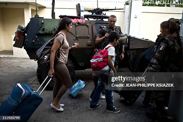 In this picture taken on April 7, 2011 French soldiers supervise the evacuation of civillians in Abidjan. A spokesman for Ivory Coast strongman...