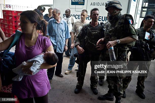 In this picture taken on April 7, 2011 French soldiers supervise the evacuation of civillians in Abidjan. A spokesman for Ivory Coast strongman...