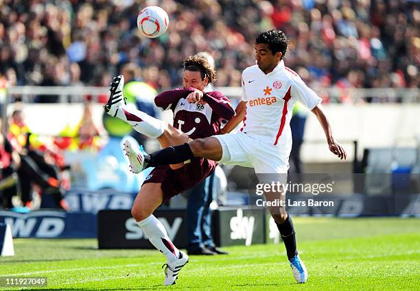 Christian Schulz of Hannover is challenged by Sami Allagui of Mainz during the Bundesliga match between Hannover 96 and FSV Mainz 05 at AWD Arena on...