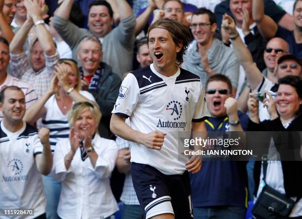 Tottenham Hotspur's Croatian midfielder Luka Modric celebrates scoring his goal with supporters during the English Premier League football match...