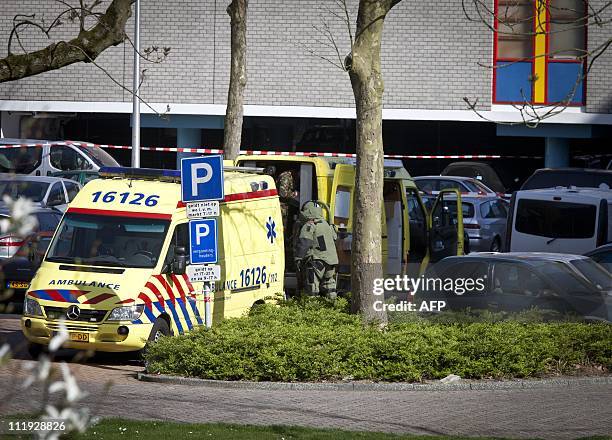 Member of the EODbomb squad, wearing a special suit, is seen at a parking lot nearby De Ridderhof shopping mall in Alphen aan de Rijn, south of...