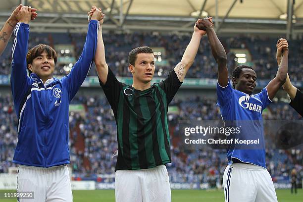 Hao Junmin, Alexander Baumjohann and Anthony Annan of Schalke of Schalke celebrate after the Bundesliga match between FC Schalke 04 and VfL Wolfsburg...