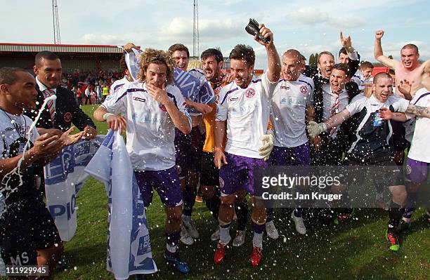 Sergio Torres and Matt Tubbs of Crawley Town celebrate with team mates at the final whistle after a win that secures promotion during the Blue Square...
