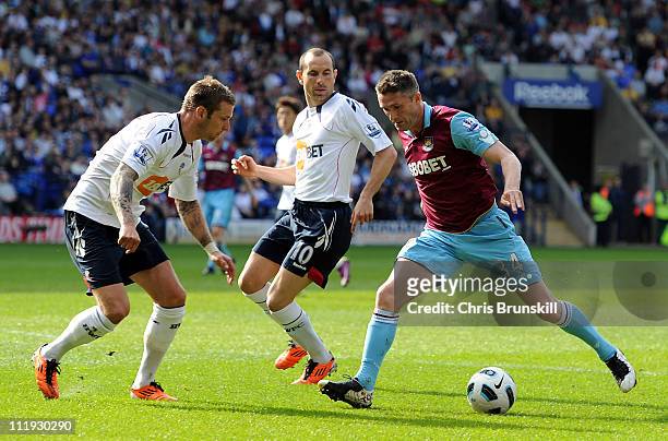 Gretar Steinsson of Bolton Wanderers competes with Robbie Keane of West Ham United during the Barclays Premier League match between Bolton Wanderers...