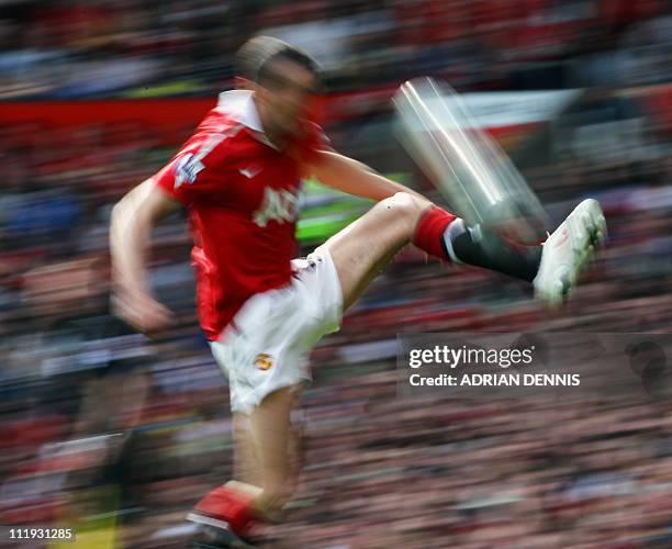 Manchester United's Irish player John O'Shea jumps to control the ball during the English Premier League football match between Manchester United and...