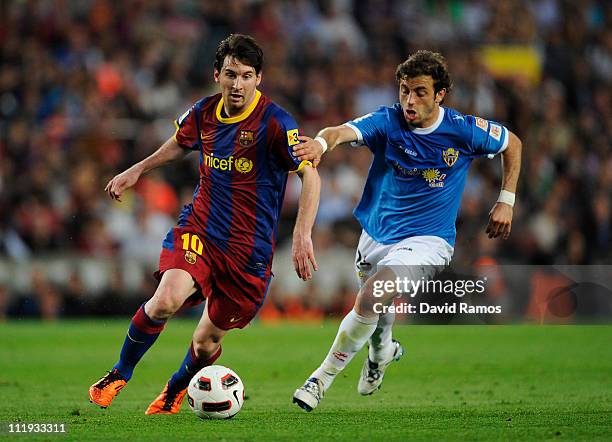 Lionel Messi of FC Barcelona fights for the ball against Hernan Bernardello of Almeria during the La Liga match between FC Barcelona and UD Almeria...