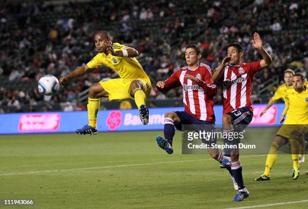 Julius James of the Columbus Crew jumps for a free kick against Zarek Valentin and Ante Jazic of Chivas USA at The Home Depot Center on April 9, 2011...