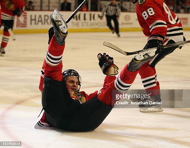 Michael Frolik of the Chicago Blackhawks slides across the ice after scoring a goal in the 2nd period against the Detroit Red Wings at the United...