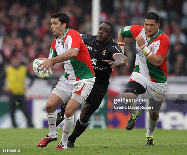 Dimitri Yachvili of Biarritz moves away from Yannick Nyanga during the Heineken Cup quarter final match between Biarritz Olympic and Toulouse at...