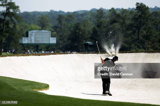 Rory McIlroy of Northern Ireland hits from the bunker on the second hole during the final round of the 2011 Masters Tournament on April 10, 2011 in...