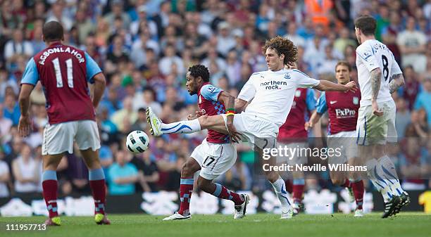 Jean II Makoun of Aston Villa challenges Fabricio Coloccini of Newcastle United during the Barclays Premier League match between Aston Villa and...