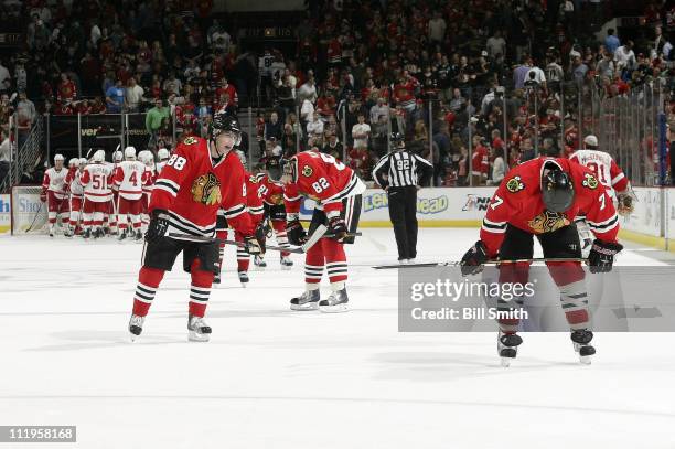 Patrick Kane, Tomas Kopecky, and Brent Seabrook of the Chicago Blackhawks skate back to the bench after losing to the Detroit Red Wings on April 10,...