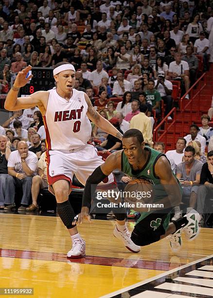 Rajon Rondo of the Boston Celtics is fouled by Mike Bibby of the Miami Heat during a game at American Airlines Arena on April 10, 2011 in Miami,...