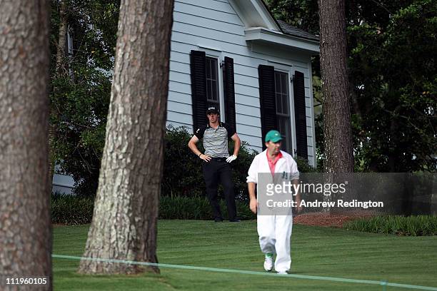 Rory McIlroy of Northern Ireland waits to plays a shot on the tenth hole as his caddie J.P. Fitzgerald looks on during the final round of the 2011...