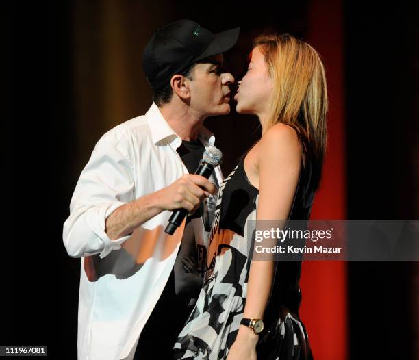 Charlie Sheen kisses Natalie Kenly on stage during his "Violent Torpedo of Truth/Defeat Is Not An Option" tour at Radio City Music Hall on April 10,...