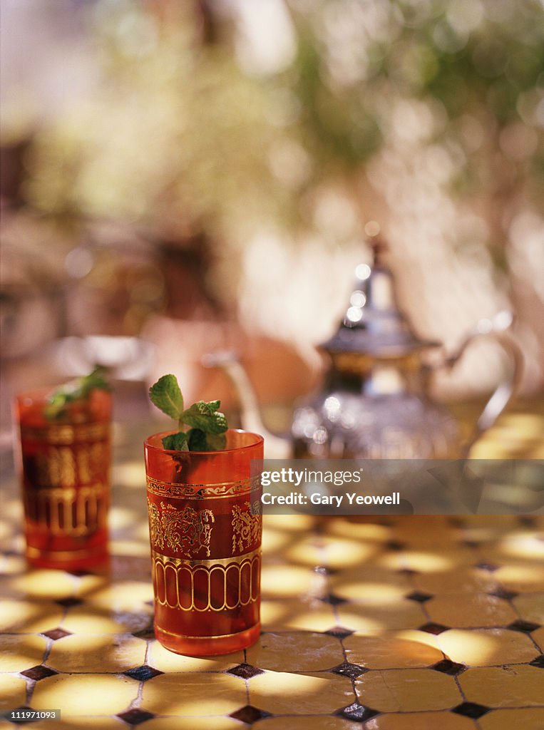 Two glasses of mint tea on a table top