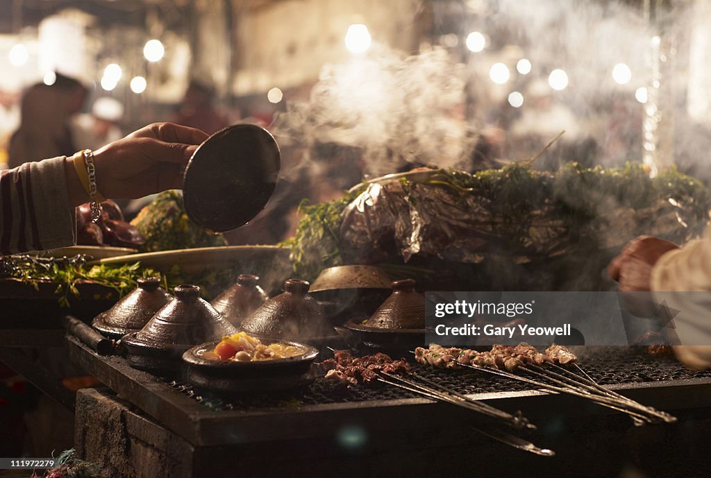 Traditional food cooked in open market stall