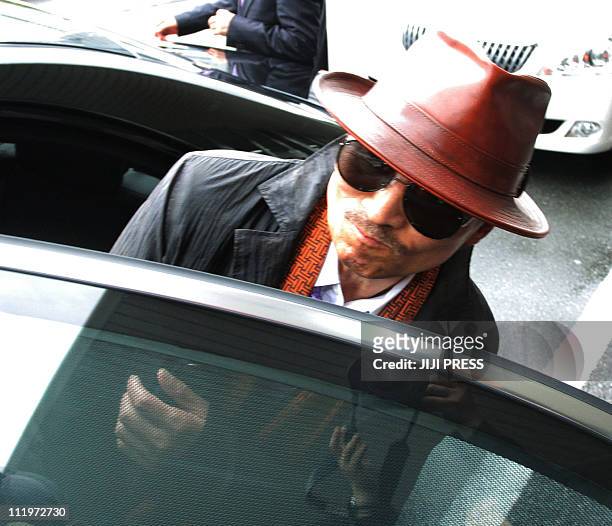 Kenichi Shinoda, the boss of Japan's largest "yakuza" gang, the Yamaguchi-gumi, gets into a car after arriving at the train station in Kobe, western...