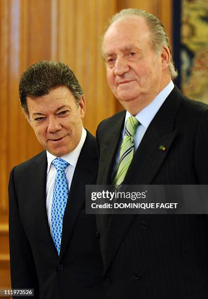 Spain's King Juan Carlos welcomes Colombian President Juan Manuel Santos as he arrives for a meeting at the Zarzuela Palace in Madrid on April 11,...