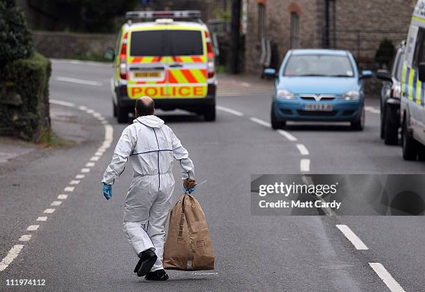 Police forensic teams work at the scene of a double shooting incident near St Lawrence Church in Westbury-sub-Mendip on April 11, 2011 near Cheddar,...