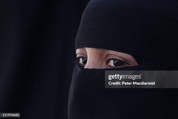 Woman wears an Islamic niqab veil stands outside the French Embassy during a demonstration on April 11, 2011 in London, England. France has become...