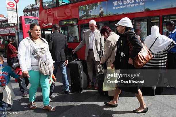 People walk past a bus stop in Brixton on April 11, 2011 in London, England. Today marks the 30th anniversary of the Brixton riots. The 1981 Brixton...