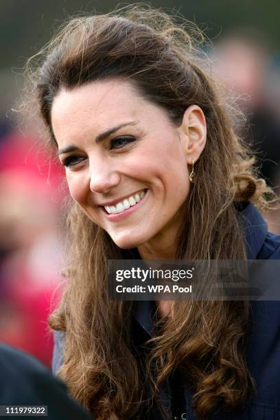 Kate Middleton, fiancee of Britain's Prince William, smiles as she greets members of the public during a visit to Witton Country Park on April 11,...