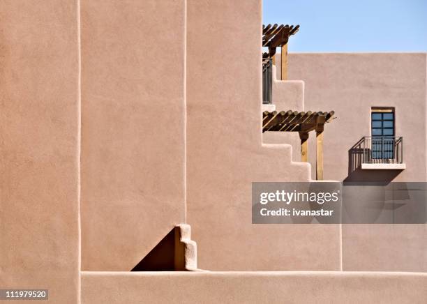 southwest santa fe adobe stucco building with wooden roof beams - adobe stockfoto's en -beelden