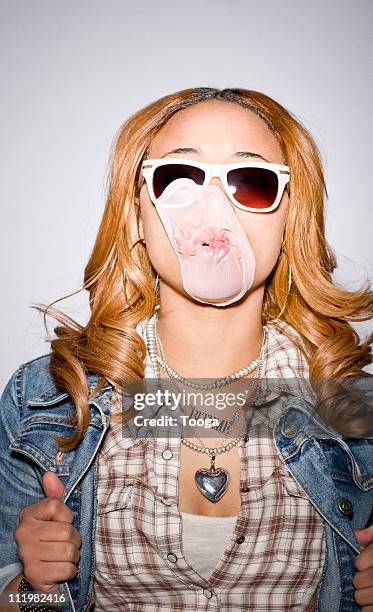 teen girl with bursted bubble on face - popped collar stockfoto's en -beelden