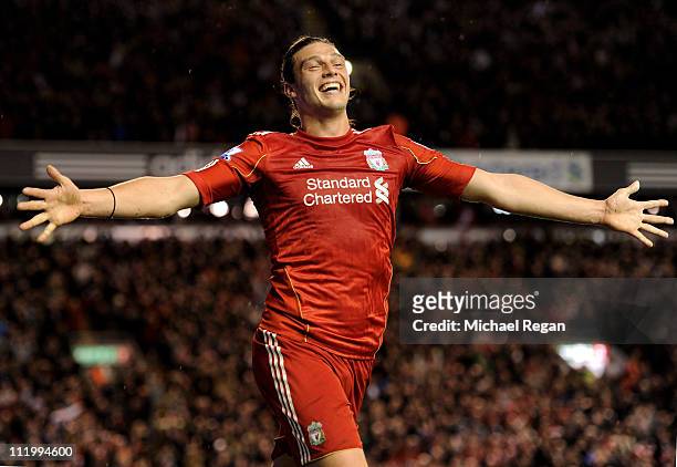 Andy Carroll of Liverpool celebrates scoring his team's third goal during the Barclays Premier League match between Liverpool and Manchester City at...