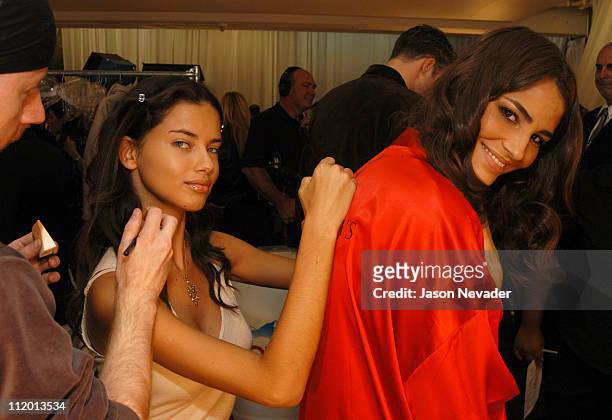 Adriana Lima autographs the Victoria's Secret robe of Fernanda Tavares
