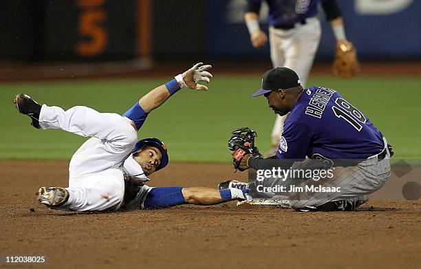 Angel Pagan of the New York Mets is tagged out by Jonathan Herrera of the Colorado Rockies trying to run out a double in the sixth inning on April...