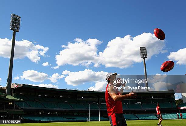 Daniel Bradshaw of the Swans catches footballs during a Sydney Swans AFL training session at Sydney Cricket Ground on April 12, 2011 in Sydney,...