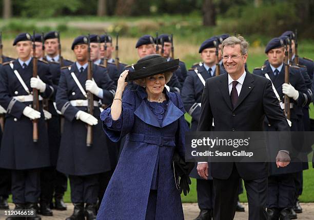 German President Christian Wulff welcomes Queen Beatrix of the Netherlands with the guard of honor at Bellevue Presidential Palace on April 12, 2011...