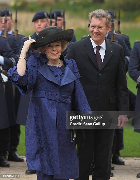 German President Christian Wulff and Queen Beatrix of the Netherlands review a guard of honor at Bellevue Presidential Palace on April 12, 2011 in...